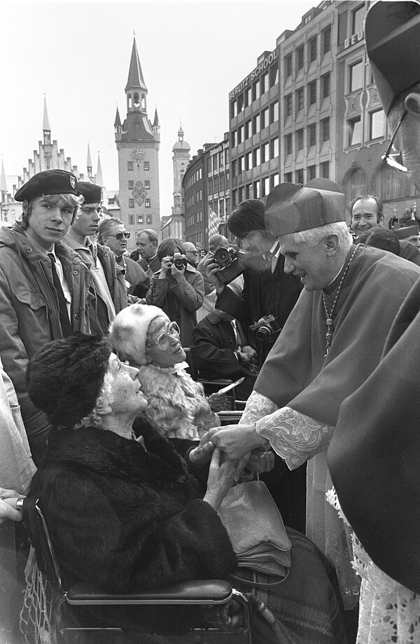 Kardinal Joseph Ratzinger nimmt 1982 Abschied von München und schüttelt die Hand einer Frau.